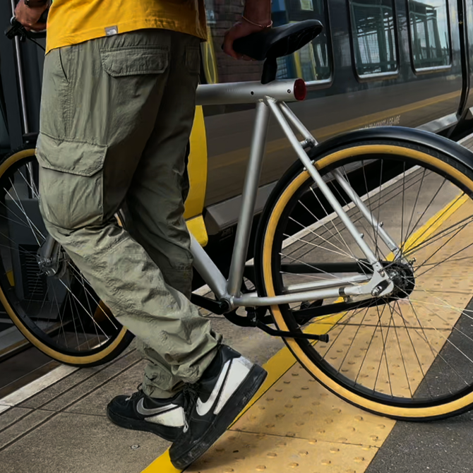 A bike being pushed onto a merseyrail train