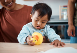 child holding rubber duck