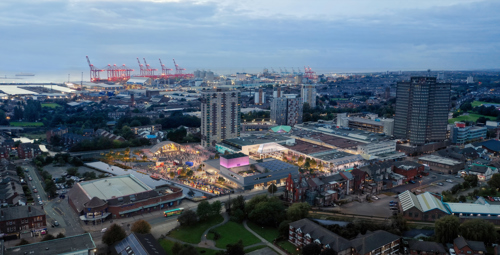 A computer generated aerial shot of the new shopping centre with lights and open spaces visible.