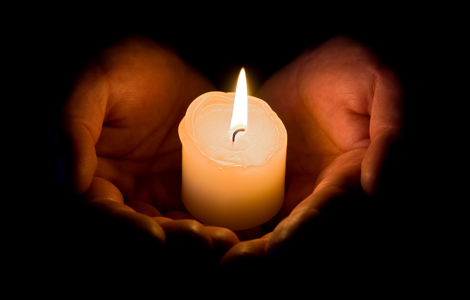 Hands holding a candle 