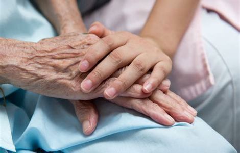 Younger and older persons' hands holding