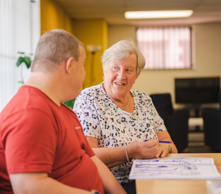 Two people looking at each other at a Carers Centre