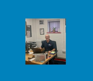 Dave Smith sitting at a desk