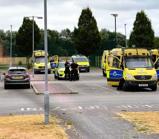 Police vehicles lined up in a car park 