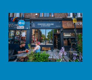 Crosby Coffee House & Roastery frontage with outdoor seating on a bustling high street.