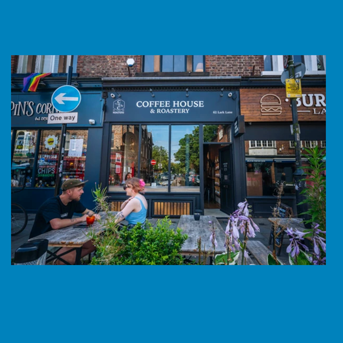 Crosby Coffee House & Roastery frontage with outdoor seating on a bustling high street.