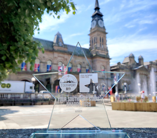 A glass star award called 'Your Southport Stars' in front of the Atkinson in Southport
